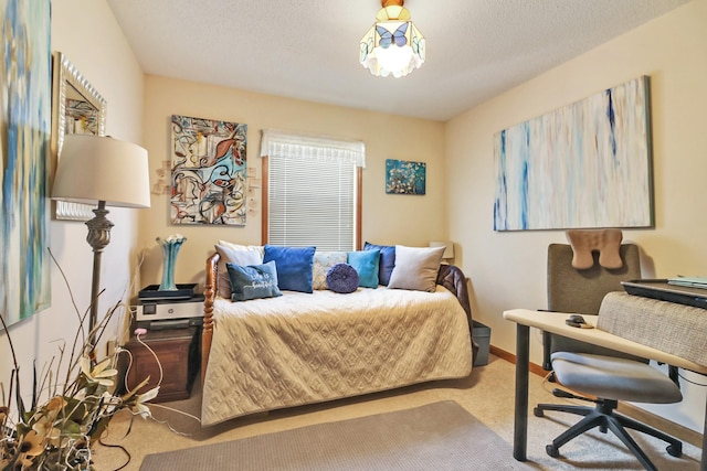 carpeted bedroom featuring a textured ceiling