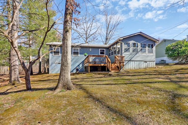 back of house with crawl space, a lawn, a deck, and stairs