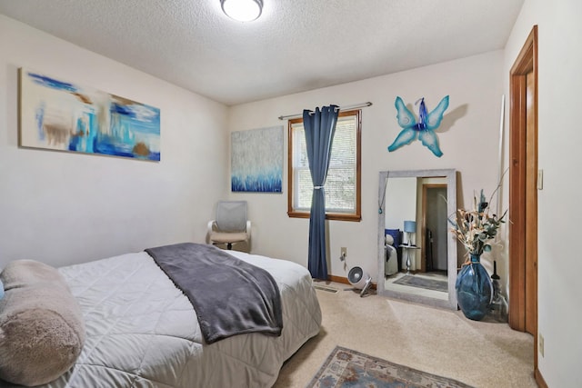 bedroom featuring a textured ceiling, baseboards, and light colored carpet