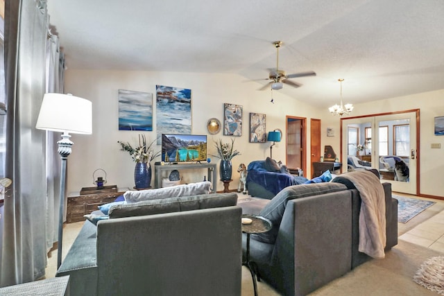 living room with lofted ceiling and ceiling fan with notable chandelier