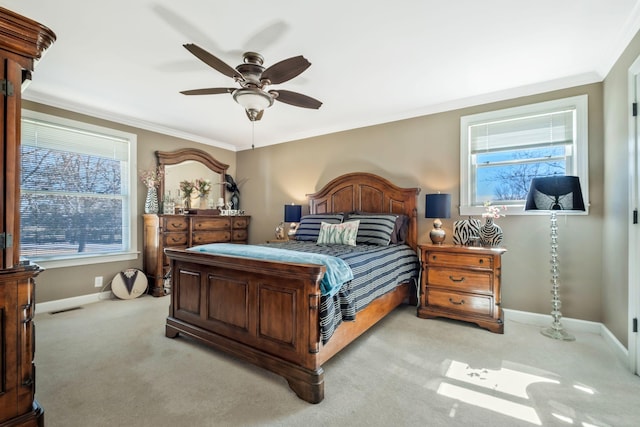 carpeted bedroom with visible vents, ornamental molding, a ceiling fan, and baseboards