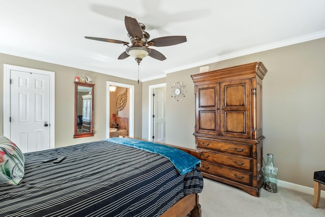 bedroom with ceiling fan, ensuite bathroom, carpet flooring, baseboards, and crown molding