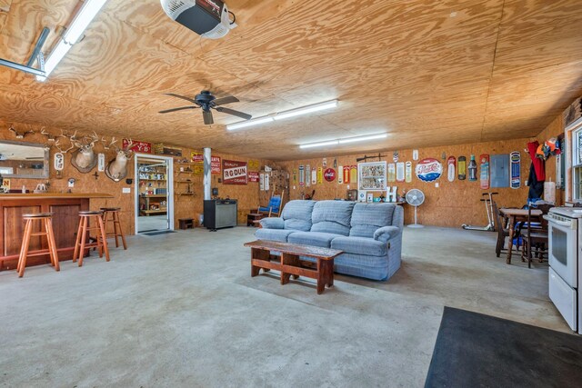 living area featuring concrete flooring and a dry bar