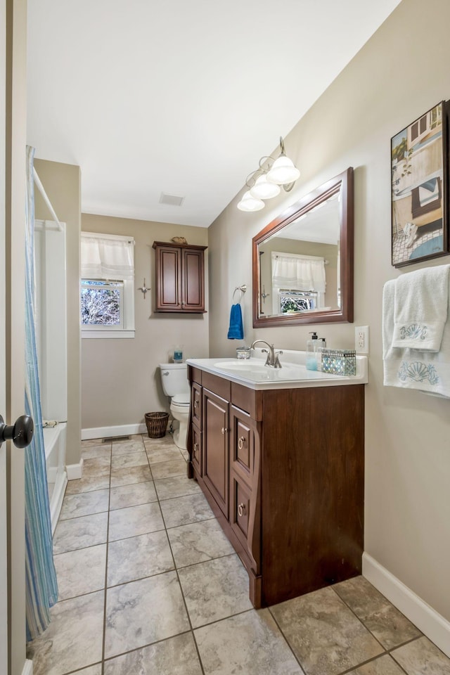 full bathroom with tile patterned floors, vanity, toilet, and baseboards