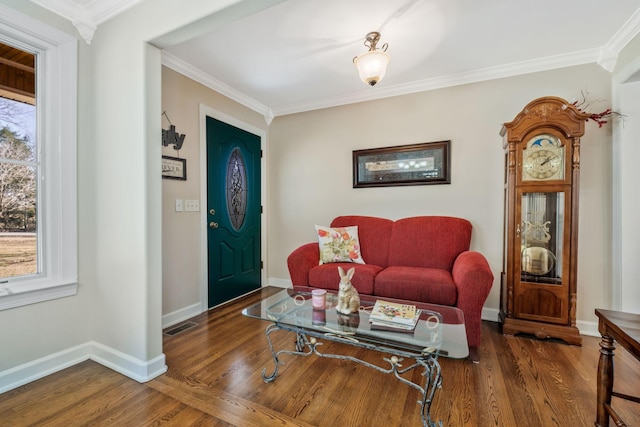 living area featuring plenty of natural light, ornamental molding, and wood finished floors