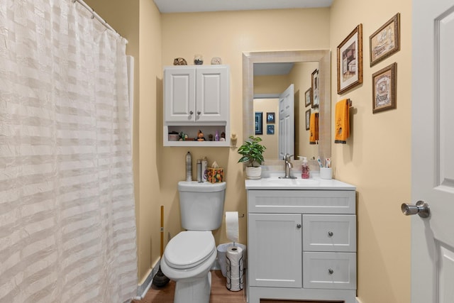 full bath with toilet, curtained shower, baseboards, and vanity