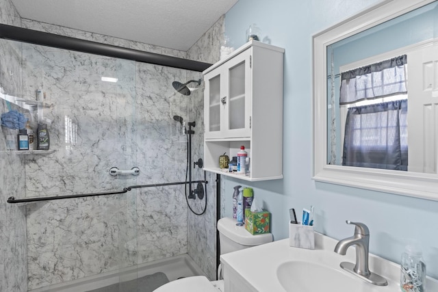 full bathroom with toilet, a textured ceiling, a marble finish shower, and vanity