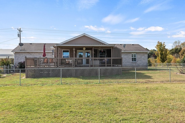 rear view of house featuring brick siding, a lawn, and a fenced backyard