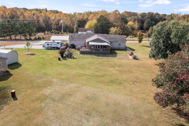 drone / aerial view featuring a wooded view