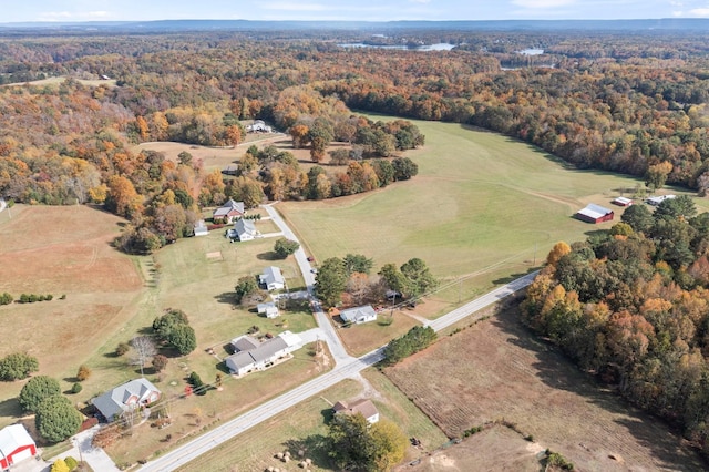 bird's eye view with a wooded view