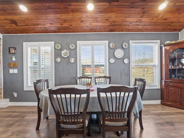 dining area featuring plenty of natural light, wood finished floors, and baseboards