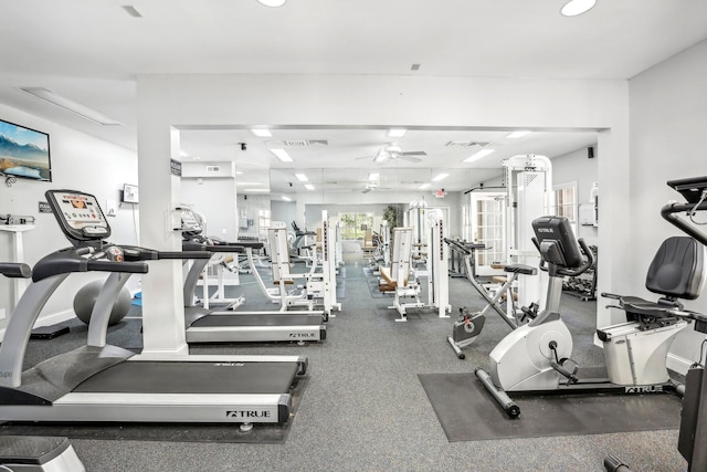 workout area with visible vents, baseboards, and a ceiling fan