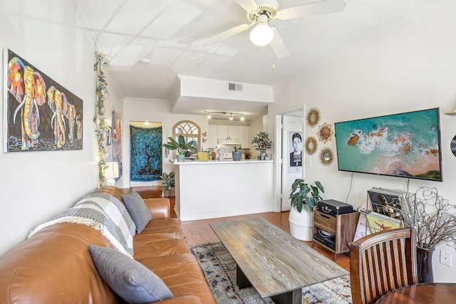 living area featuring visible vents, ceiling fan, and wood finished floors