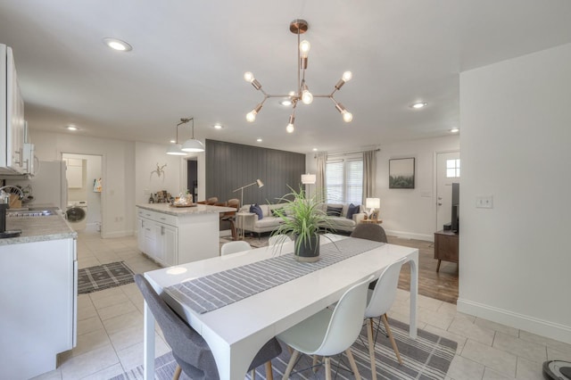 dining area featuring recessed lighting, washer / clothes dryer, baseboards, and light tile patterned floors