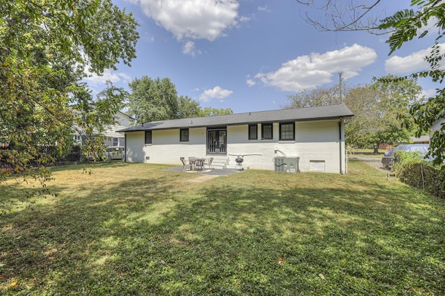 rear view of house with a patio area, fence, and a yard