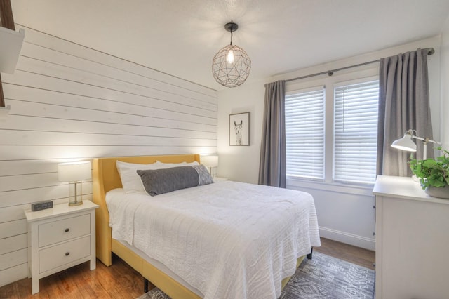 bedroom featuring wood finished floors and baseboards