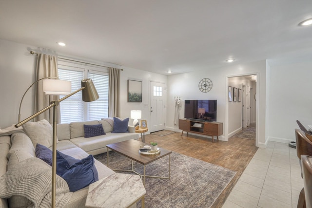 living room with light tile patterned floors, baseboards, and recessed lighting