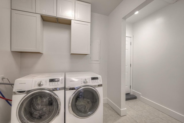 washroom featuring cabinet space, washing machine and dryer, light tile patterned floors, and baseboards