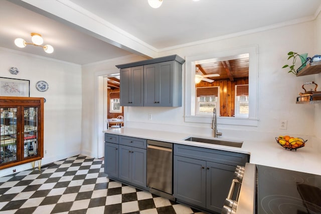 kitchen featuring light floors, a sink, light countertops, and stainless steel appliances