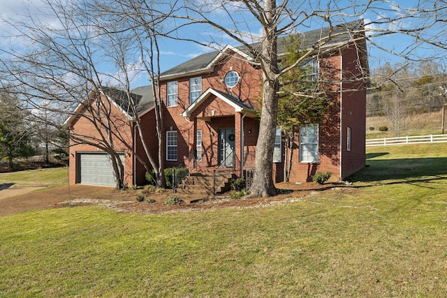 view of front of property featuring a garage, brick siding, a front yard, and fence