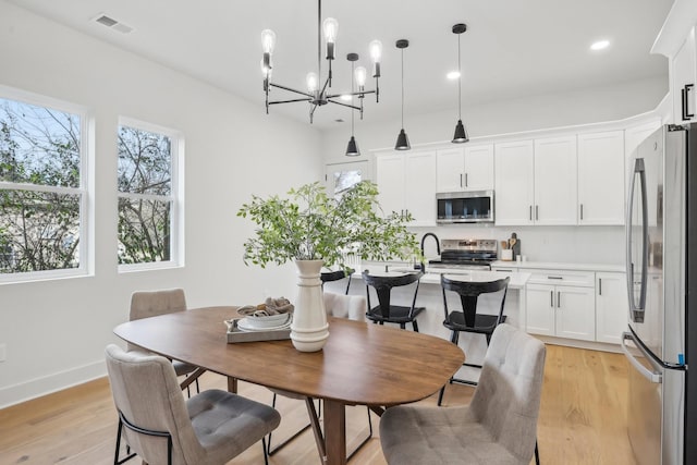 dining space with recessed lighting, visible vents, light wood-style flooring, and baseboards