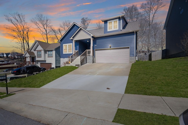 view of front facade featuring a lawn, driveway, and a garage