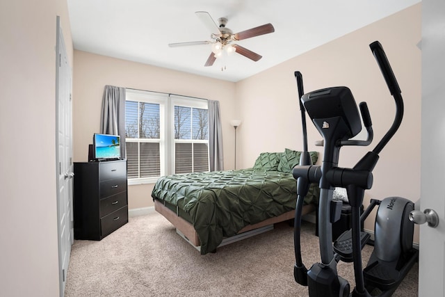 bedroom with light colored carpet and a ceiling fan