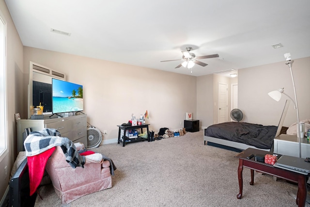 carpeted bedroom with a closet, visible vents, baseboards, and ceiling fan