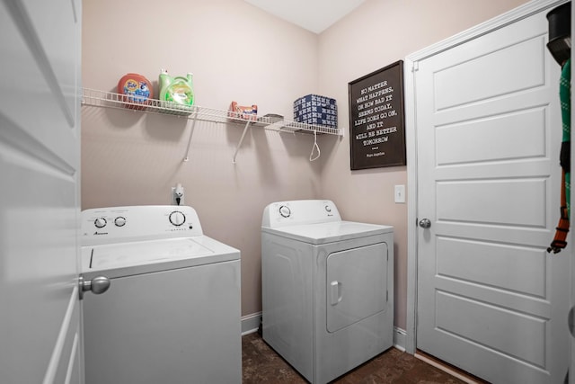 laundry area featuring washer and clothes dryer, laundry area, and baseboards