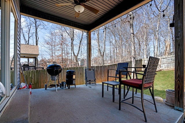 view of patio / terrace with grilling area, a fenced backyard, and ceiling fan