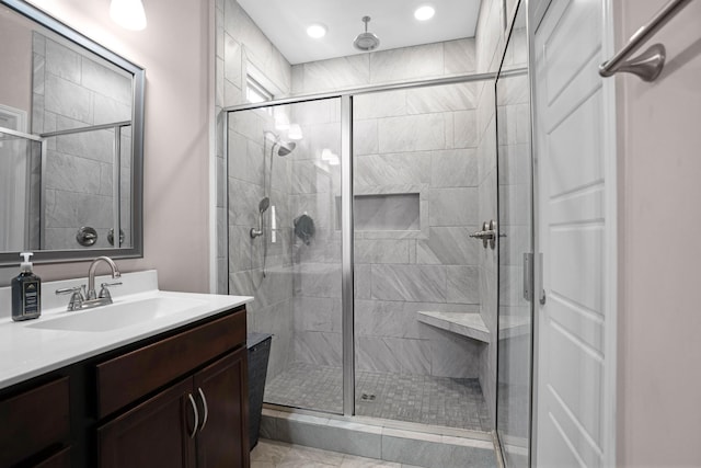 bathroom featuring a stall shower and vanity