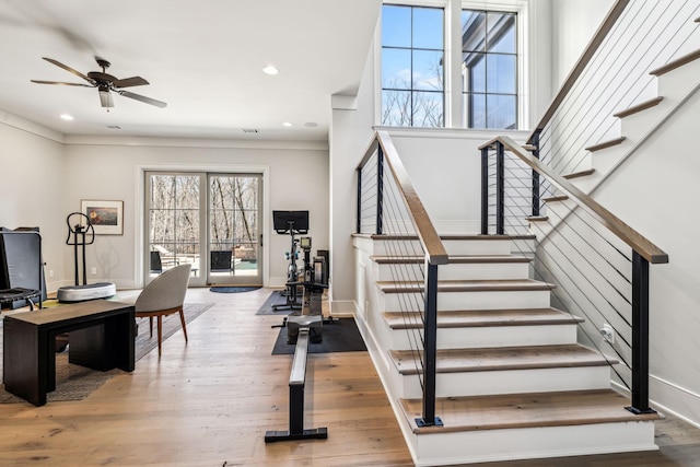 stairs with baseboards, ceiling fan, wood finished floors, and recessed lighting