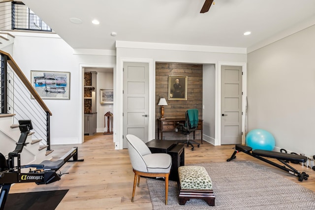 exercise room featuring light wood finished floors, a ceiling fan, and recessed lighting