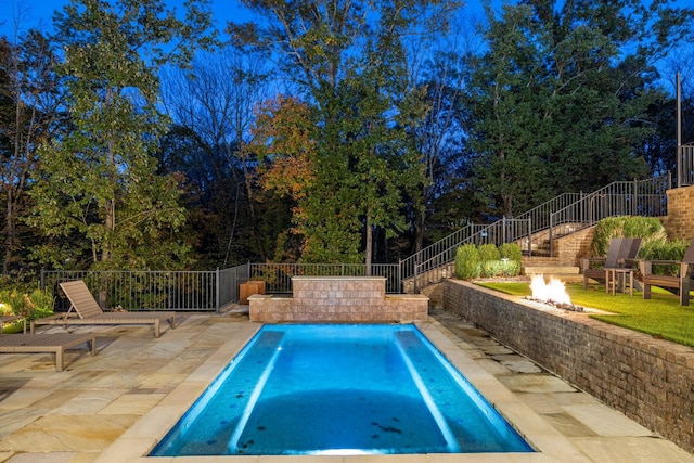 view of pool featuring an outdoor fire pit, a patio area, and stairway