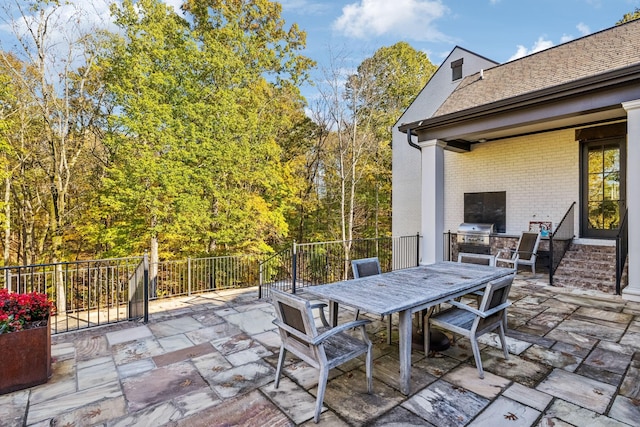 view of patio / terrace with outdoor dining space and a grill