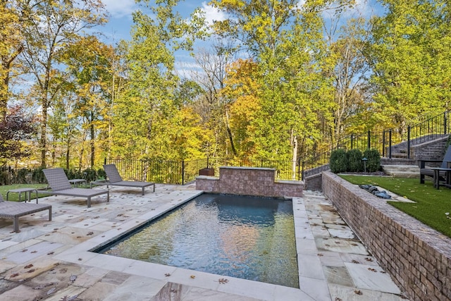 view of pool featuring a patio, fence, and a fenced in pool