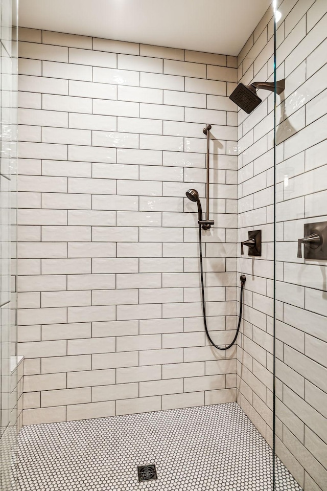 full bath with a tile shower