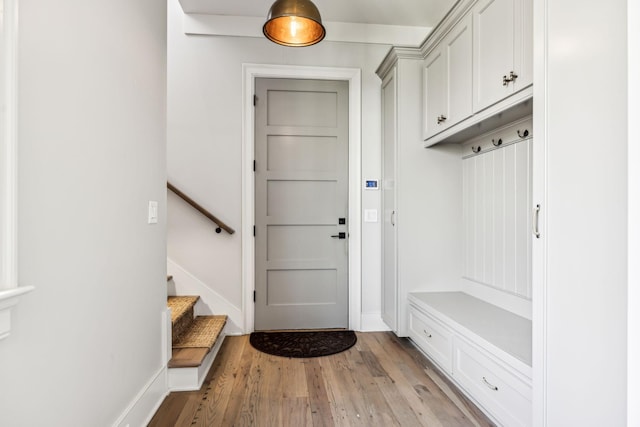 mudroom with light wood-style flooring and baseboards