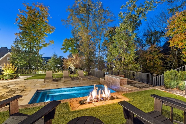 view of pool featuring a fire pit, a patio, a yard, and a fenced backyard