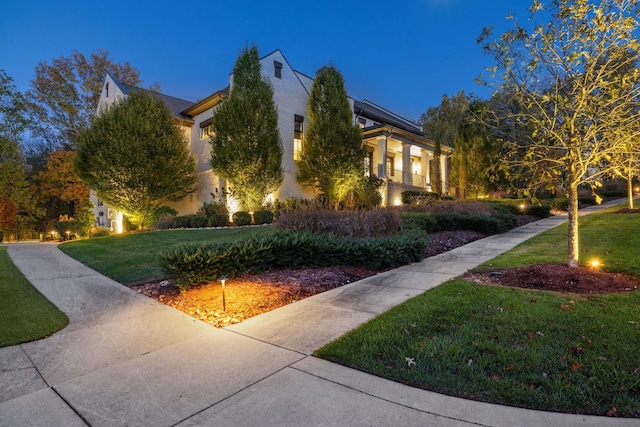 view of front of house featuring a front lawn and stucco siding