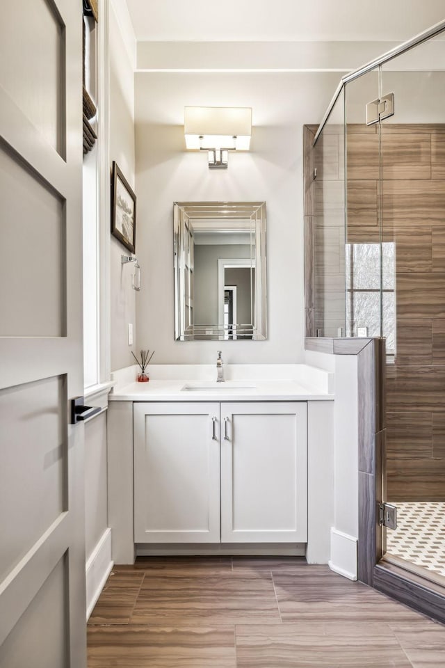 full bathroom with a shower stall and vanity