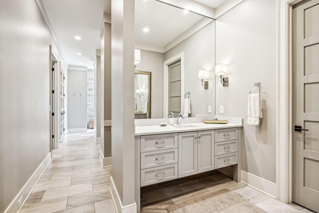 bathroom with recessed lighting, vanity, baseboards, and wood tiled floor