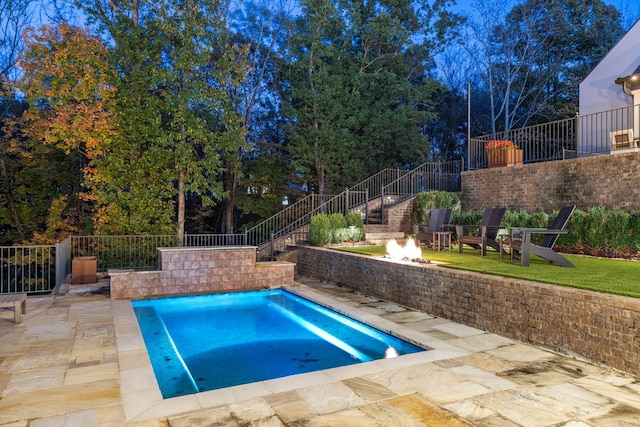 view of pool with a fire pit, a patio area, and stairs