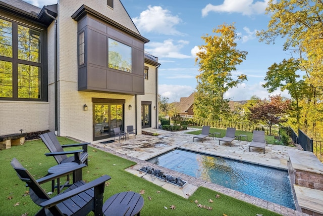 view of pool featuring a patio area, fence, a fenced in pool, and a yard