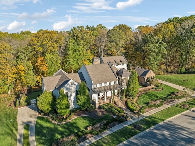 drone / aerial view with a wooded view