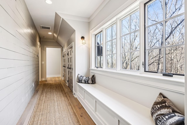 mudroom featuring wooden walls, hardwood / wood-style floors, visible vents, and recessed lighting