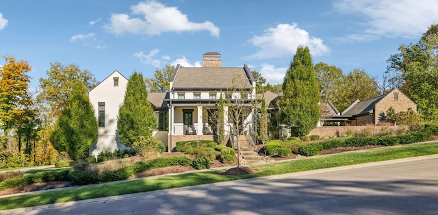 view of front of property featuring stairway and a chimney