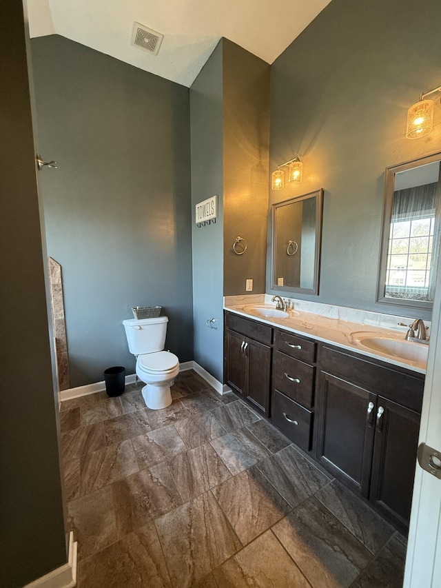 bathroom featuring baseboards, visible vents, a sink, and toilet