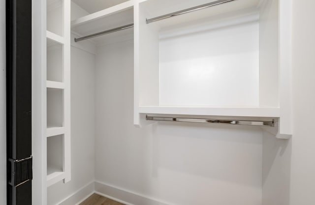 walk in closet featuring wood finished floors