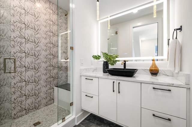 full bath with a stall shower and vanity